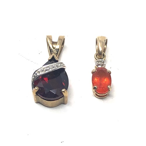 111 - 4 x 9ct gold gemstone pendants inc. garnet, topaz & diamond (2.6g)