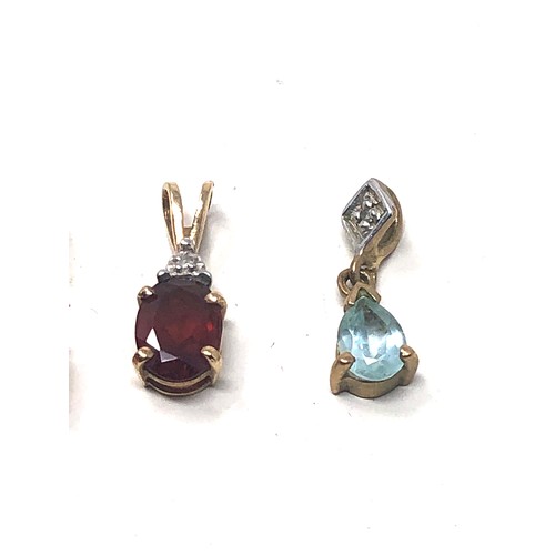 111 - 4 x 9ct gold gemstone pendants inc. garnet, topaz & diamond (2.6g)