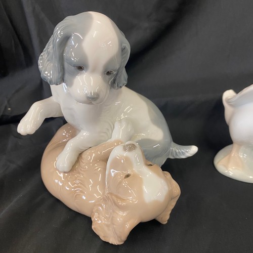 64 - Selection of Nao pottery figures includes Two puppies playing, geese etc