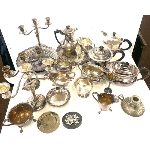 242 - Large selection of silver plated items includes Jugs, Tea pot, candle sticks etc