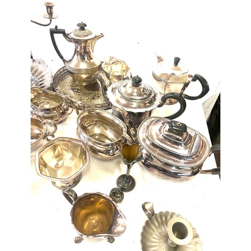 242 - Large selection of silver plated items includes Jugs, Tea pot, candle sticks etc