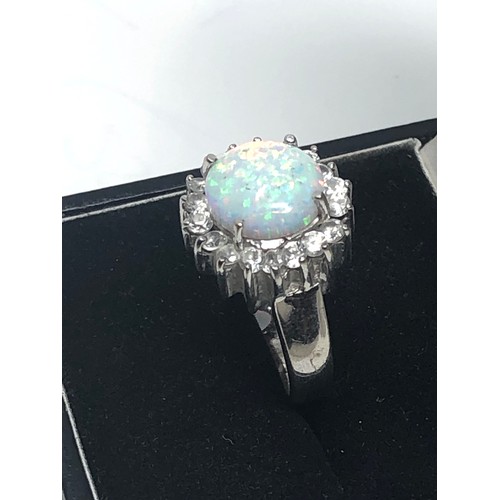 601 - 14ct white gold opal & clear gemstone halo ring (6.1g)