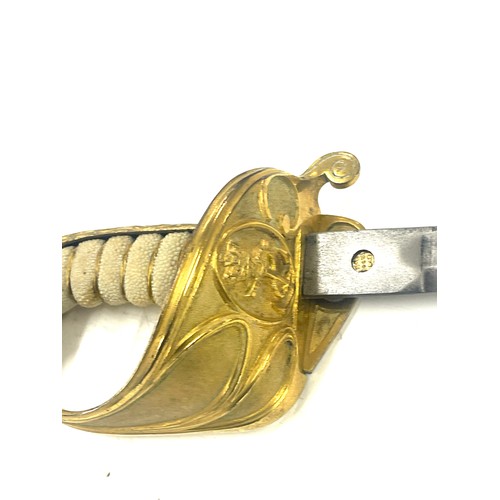 553 - British naval sword, blade length approximately 29 inches, together with a Paisleys Glasgow tunic