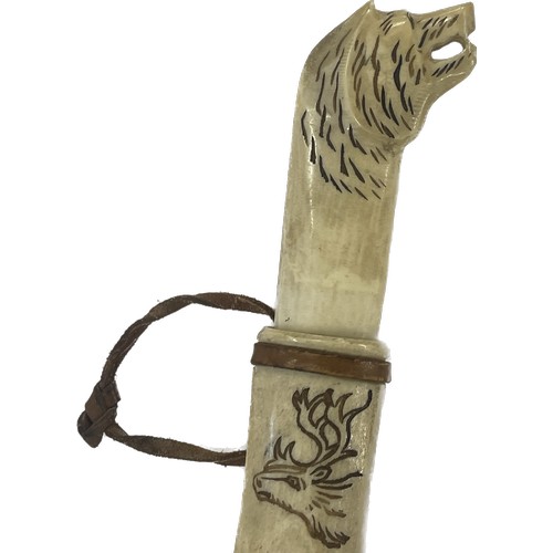 532 - Tribal art Sami knife, bone handle and scabbard, decorated with reindeer and sledge, hilt is the sha... 