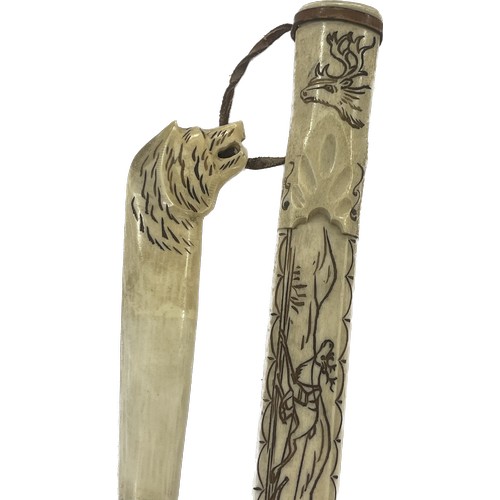 532 - Tribal art Sami knife, bone handle and scabbard, decorated with reindeer and sledge, hilt is the sha... 