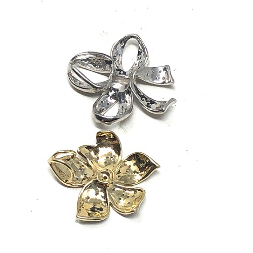 108 - 2 x 9ct gold diamond set pendants inc. ribbon & flower (5.4g)