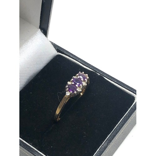 269 - 9ct gold diamond & amethyst trilogy ring (2.3g)