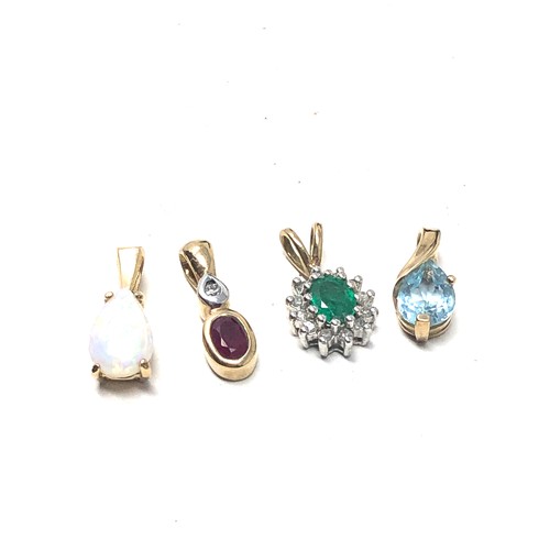 221 - 4 x 9ct gold gemstone pendants inc. topaz, emerald, opal, ruby & diamond (2.8g)