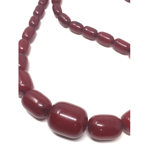 106 - Fine cherry amber bakelite barrel bead necklace large graduated  beads with good internal streaking ... 