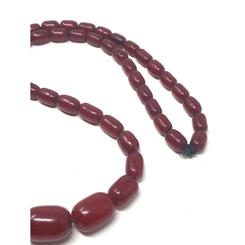 106 - Fine cherry amber bakelite barrel bead necklace large graduated  beads with good internal streaking ... 