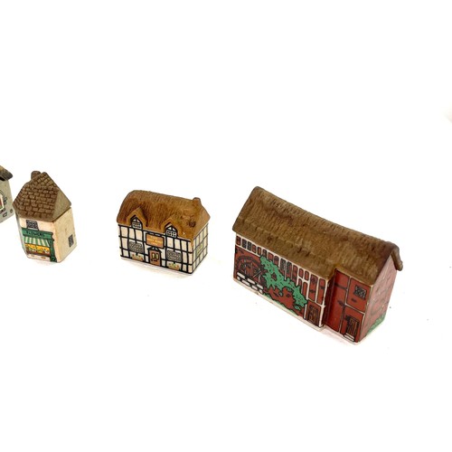 629 - Selection of vintage Wade village miniatures, to include St Sebastin Church, Flower shop etc