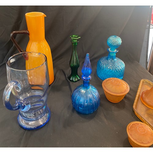 894 - Large selection of coloured glassware includes decanters, dressing table set etc