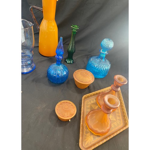 894 - Large selection of coloured glassware includes decanters, dressing table set etc