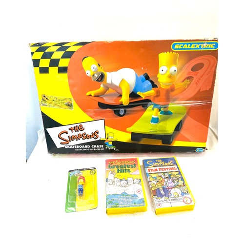 792 - The simpsons collection scalextric skateboard chase, simpsons figure, classic VHS and DVDs