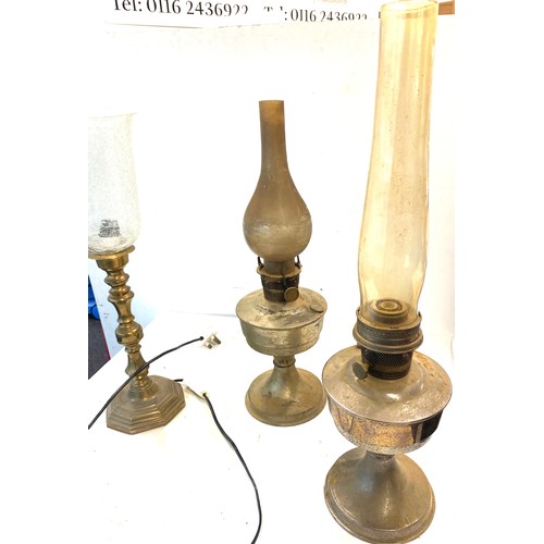 704 - 2 Vintage oil lamps together with a glass shade electric lamp, untested