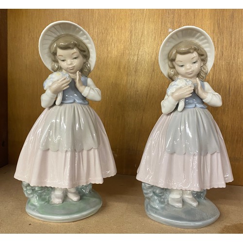 656 - Matching Nao girl holding flowers wearing bonnet figures, height 20cm