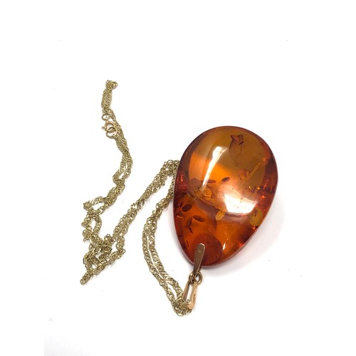 303 - 14ct gold bail baltic amber pendant on 9ct gold chain (11.6g)