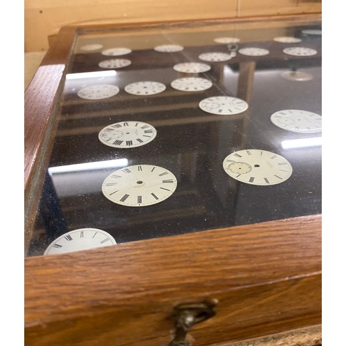 712 - Oak display case of watch faces measures approx height 32.5 inches tall by 22.5 inches wide