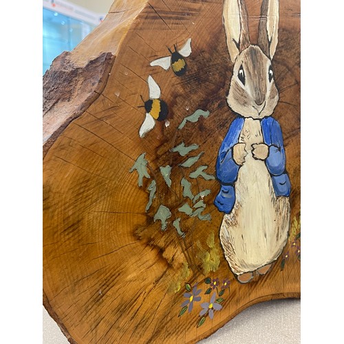 768 - Hand painted peter Rabbit log slice measures approx 15 inches tall 17 inches wide