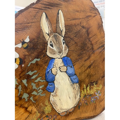 768 - Hand painted peter Rabbit log slice measures approx 15 inches tall 17 inches wide