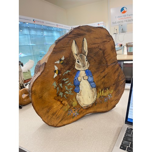 768 - Hand painted peter Rabbit log slice measures approx 15 inches tall 17 inches wide