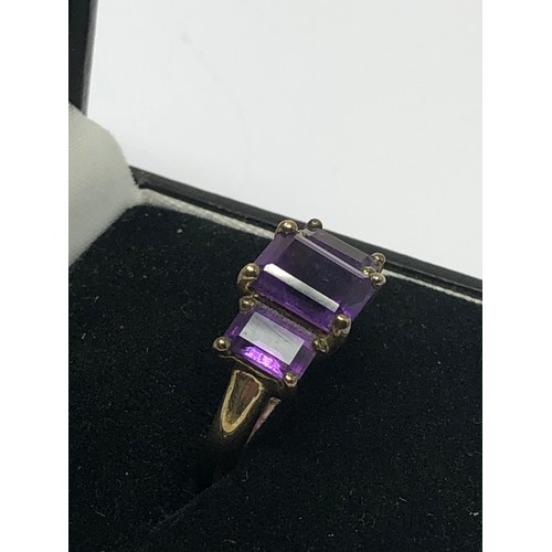 290 - 9ct gold amethyst trilogy ring (2.6g)