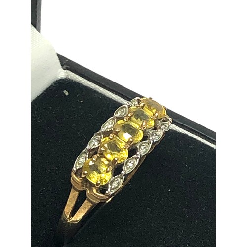 240 - 9ct gold yellow sapphire five stone ring with diamond accents (2.7g)