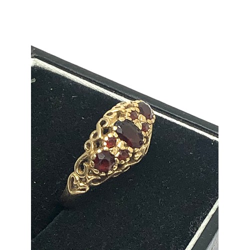 239 - 9ct gold garnet seven stone gypsy setting ring (2g)