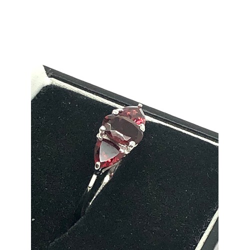 202 - 10ct white gold garnet set trillogy ring (1.7g)