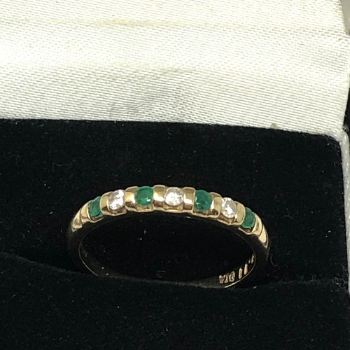 125 - 9ct gold emerald and diamond half eternity ring (1.8g)