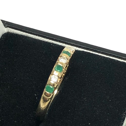 125 - 9ct gold emerald and diamond half eternity ring (1.8g)