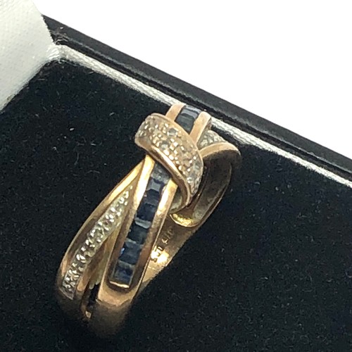 203 - 9ct gold diamond and sapphire set crossover knot ring (3.2g)