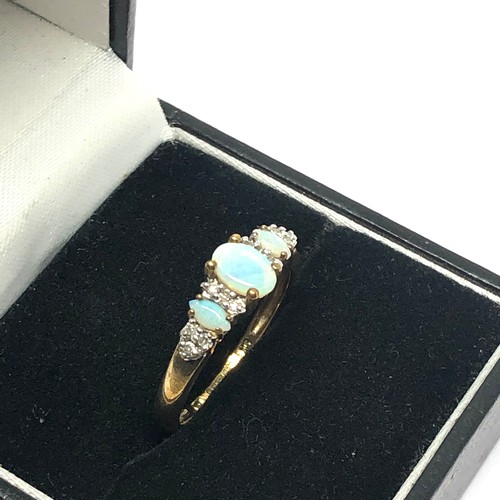 186 - 9ct gold diamond accented opal dress ring (2g)
Size N