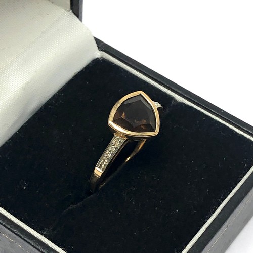 182 - 9ct gold diamond accented trilliant cut smokey quartz dress ring (2.3g)