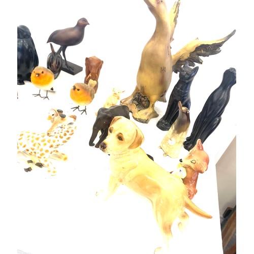 737 - Large selection of dog figures includes Carved wooden, plastic, egyptian cats etc