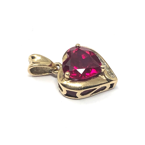 119 - 9ct gold diamond & red stone set pendant measures approx 1.7cm drop weight 1.2g