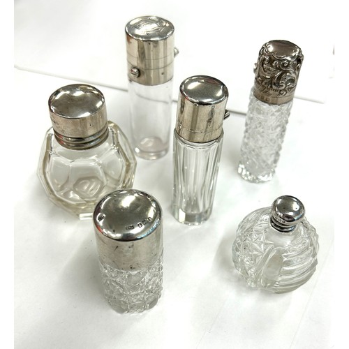 486 - Six antique silver topped scent/perfume bottles