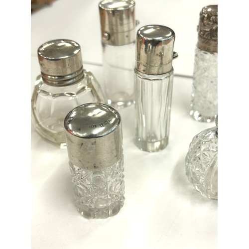 486 - Six antique silver topped scent/perfume bottles