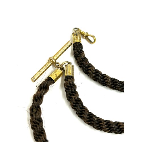 481 - Victorian aplaited hair Albert watch chain with yellow metal fittings and watch fob