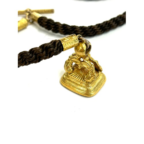 481 - Victorian aplaited hair Albert watch chain with yellow metal fittings and watch fob