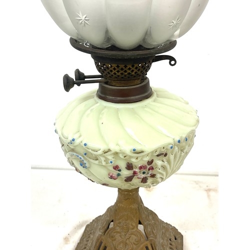 77 - Victorian oil lamp on cast base measures 25 inches tall