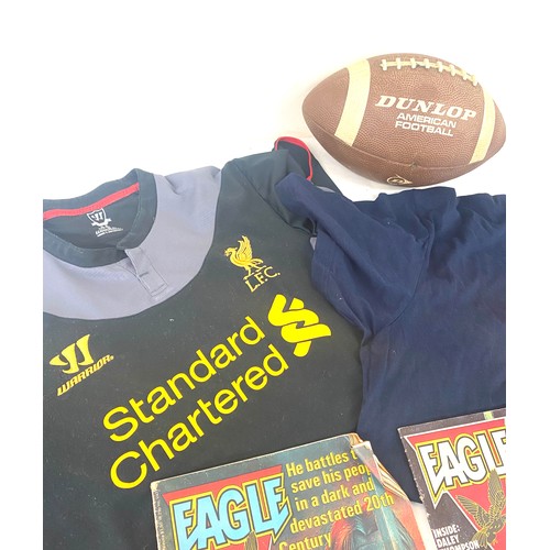 184 - Liverpool and Manchester United t shirts, American football and 2 vintage Eagle comics