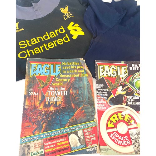 184 - Liverpool and Manchester United t shirts, American football and 2 vintage Eagle comics