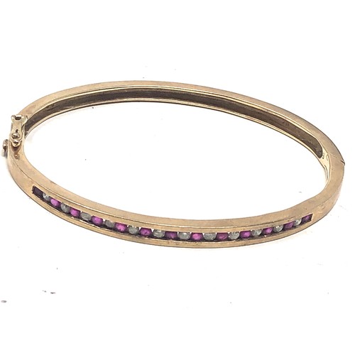 140 - 9ct gold ruby & diamond channel setting bangle (15g)