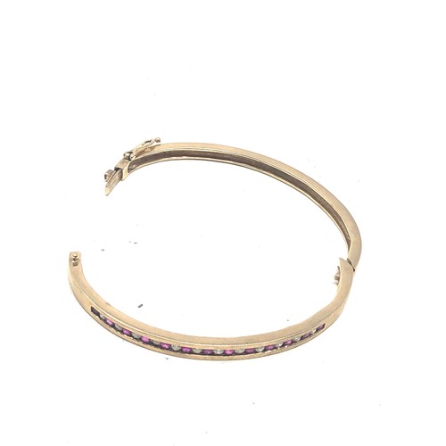 140 - 9ct gold ruby & diamond channel setting bangle (15g)