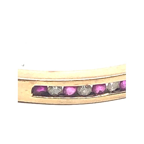 140 - 9ct gold ruby & diamond channel setting bangle (15g)