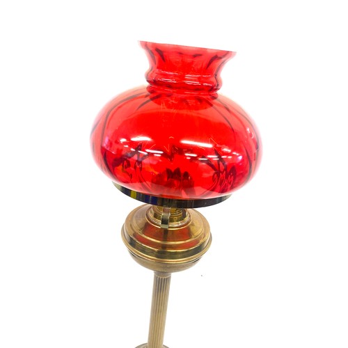 99A - Vintage cranberry and brass oil lamp measures approx 28 inches tall