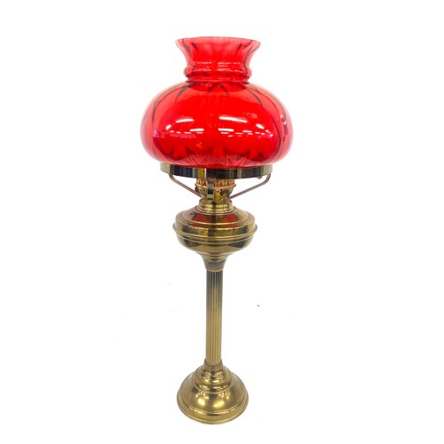 99A - Vintage cranberry and brass oil lamp measures approx 28 inches tall