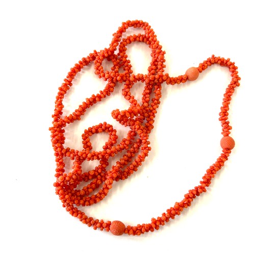 633 - Antique Georgian craved coral necklace. Weighs approx 54 grams. Measures approx 126 cm in length