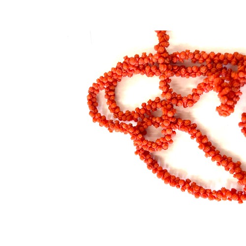 633 - Antique Georgian craved coral necklace. Weighs approx 54 grams. Measures approx 126 cm in length